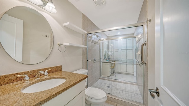 bathroom featuring tile patterned flooring, vanity, and toilet