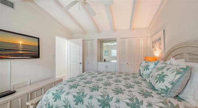 bedroom with vaulted ceiling with beams, ceiling fan, and multiple closets