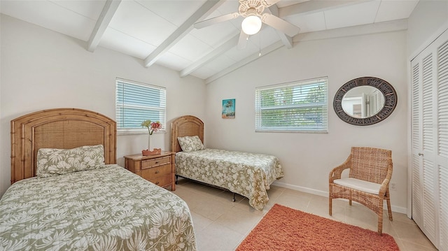 tiled bedroom with vaulted ceiling with beams, a closet, and ceiling fan