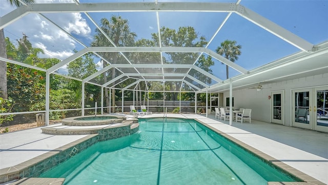 view of swimming pool featuring a lanai, an in ground hot tub, ceiling fan, and a patio