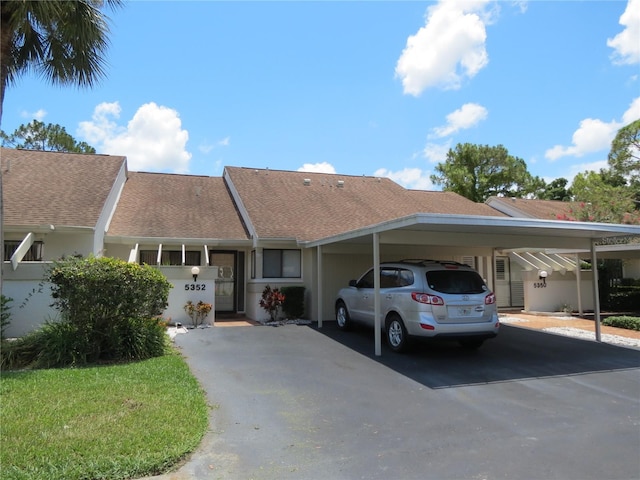 single story home featuring a carport