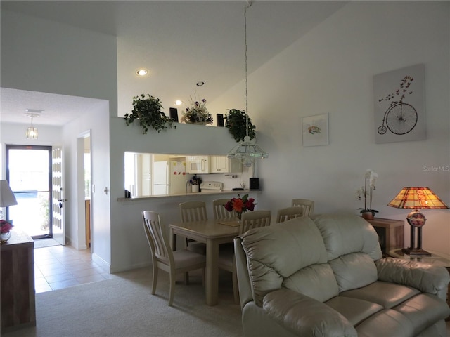 living room featuring light colored carpet and high vaulted ceiling