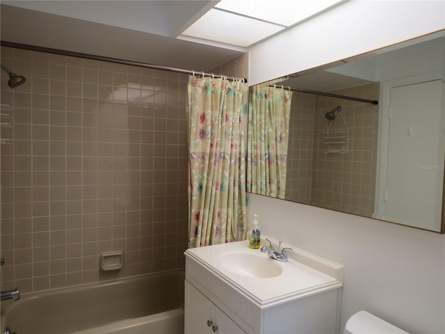 full bathroom featuring toilet, vanity, and shower / tub combo with curtain