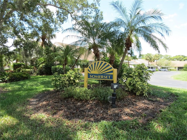 community / neighborhood sign with a yard