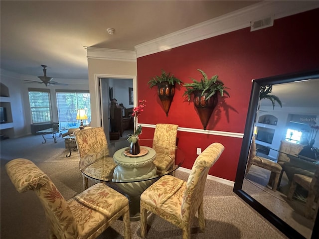 dining area with ceiling fan, crown molding, and carpet flooring