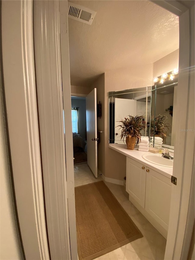 bathroom featuring vanity and tile patterned flooring