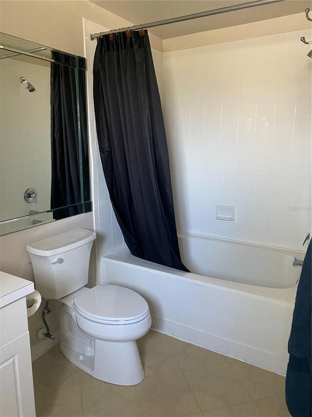 full bathroom with shower / tub combo, vanity, tile patterned flooring, and toilet