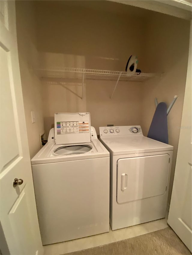 clothes washing area featuring washing machine and clothes dryer