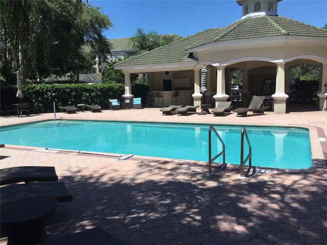 view of swimming pool featuring a patio area and a gazebo