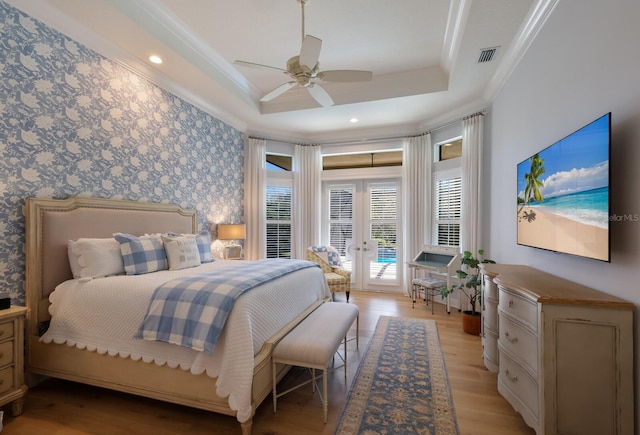 bedroom with ornamental molding, access to outside, a raised ceiling, ceiling fan, and light hardwood / wood-style flooring