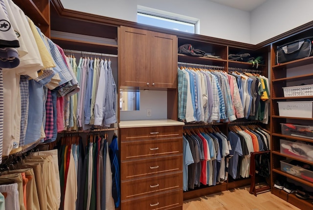 spacious closet featuring light hardwood / wood-style floors