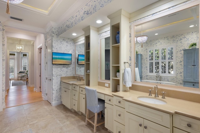 bathroom with crown molding, vanity, a notable chandelier, and hardwood / wood-style flooring