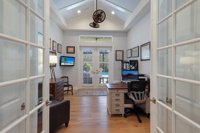 home office with french doors, hardwood / wood-style flooring, and high vaulted ceiling