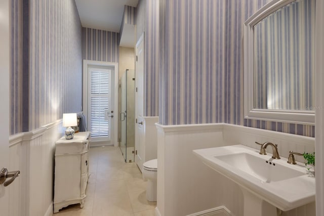 bathroom with sink, tile patterned flooring, an enclosed shower, and toilet