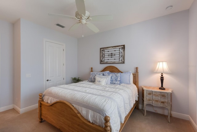 bedroom featuring ceiling fan, light colored carpet, and a closet