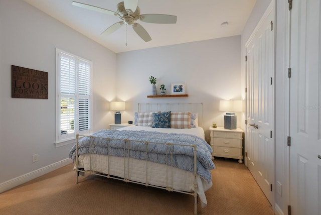 bedroom with ceiling fan and light colored carpet