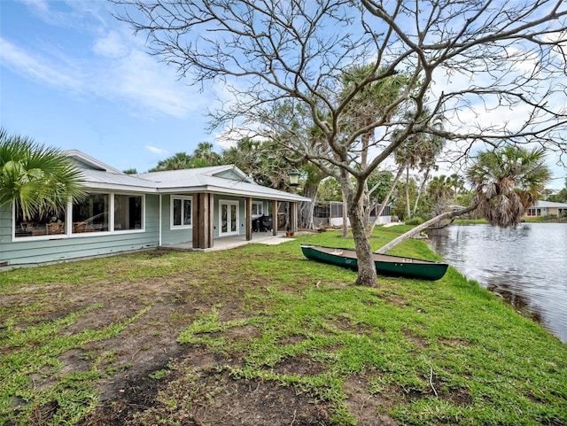 view of yard featuring a water view and a patio