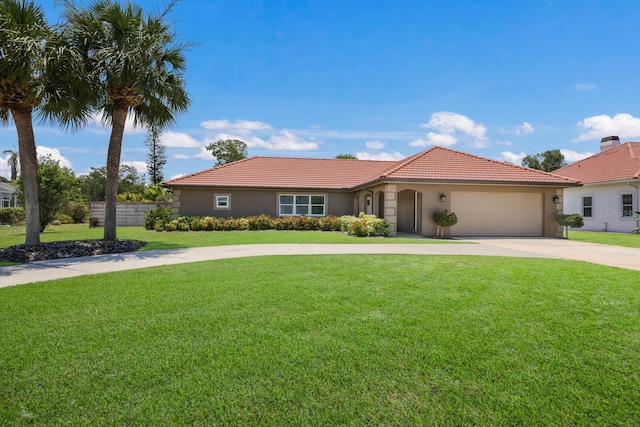 mediterranean / spanish-style house featuring a front yard and a garage