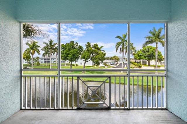 unfurnished sunroom featuring a water view and a wealth of natural light