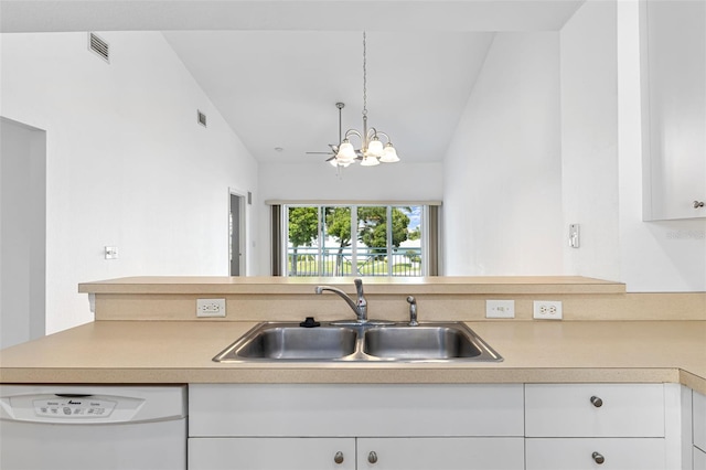 kitchen featuring dishwasher, white cabinets, vaulted ceiling, and sink