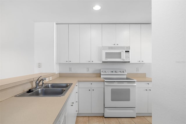 kitchen with white cabinets, electric range oven, and sink