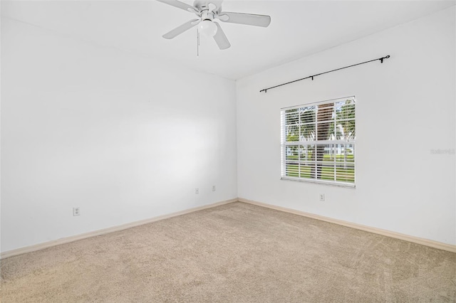 spare room featuring ceiling fan and carpet floors