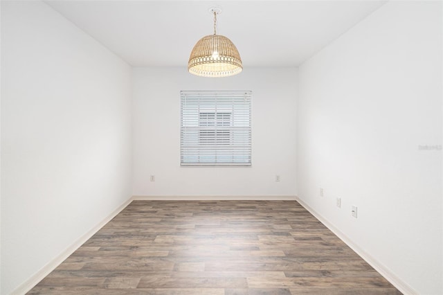 spare room with dark hardwood / wood-style floors