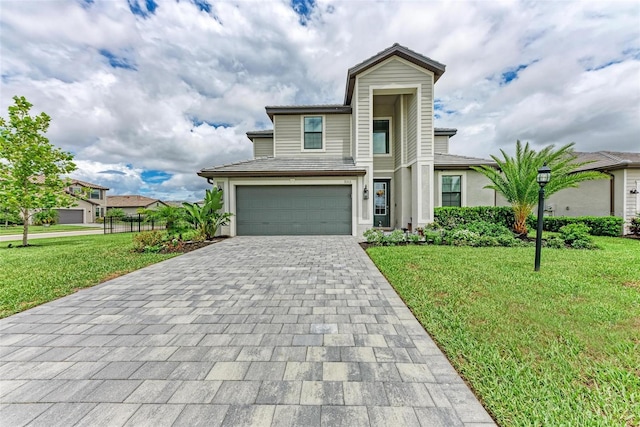 view of front facade with a front yard and a garage