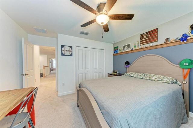 carpeted bedroom featuring a closet and ceiling fan