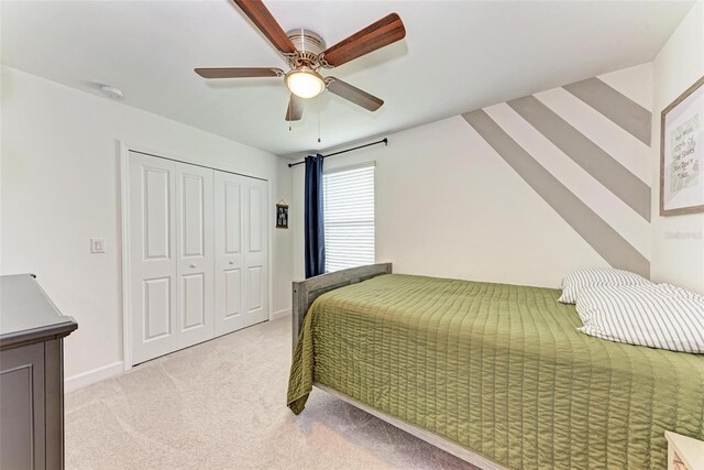 carpeted bedroom featuring a closet and ceiling fan