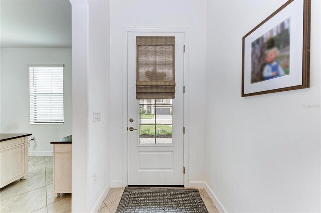 doorway featuring light tile patterned floors