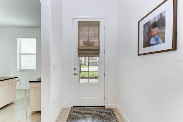 entryway with light tile patterned flooring