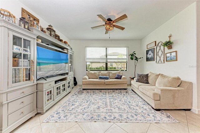 living room with ceiling fan and light tile patterned floors