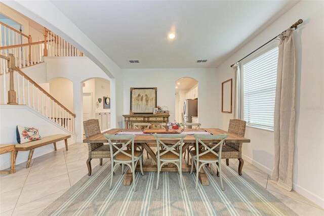 dining area featuring light tile patterned flooring