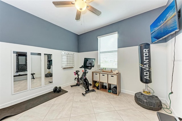 exercise room with ceiling fan and light tile patterned floors