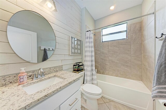 full bathroom with toilet, shower / bath combo, tile patterned floors, and wood walls