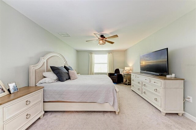 bedroom with light carpet and ceiling fan