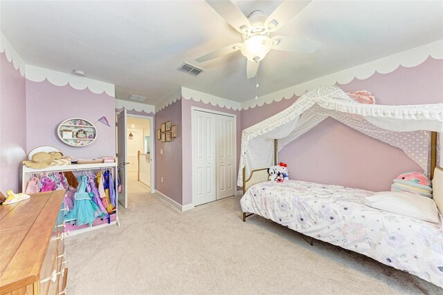 carpeted bedroom with ceiling fan and a closet