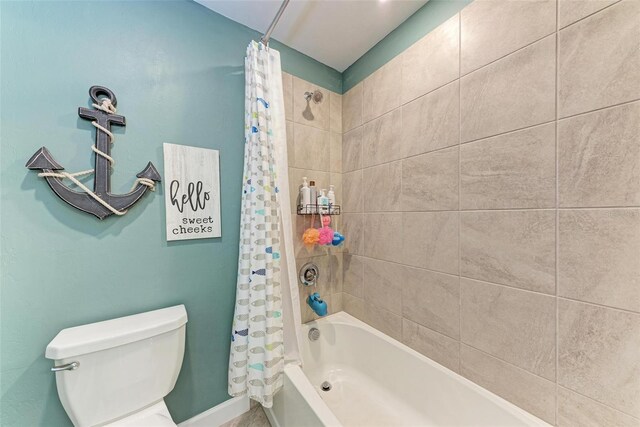 bathroom with toilet and shower / bathtub combination with curtain