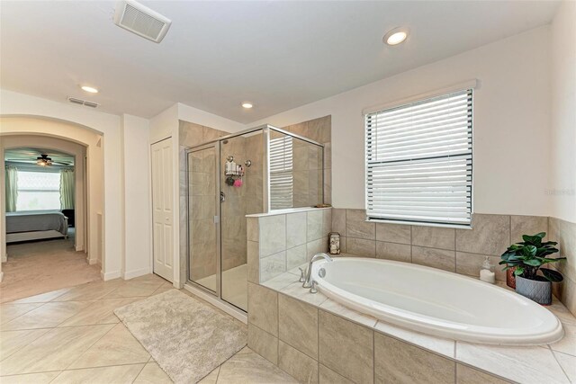 bathroom featuring tile patterned floors, a healthy amount of sunlight, and shower with separate bathtub