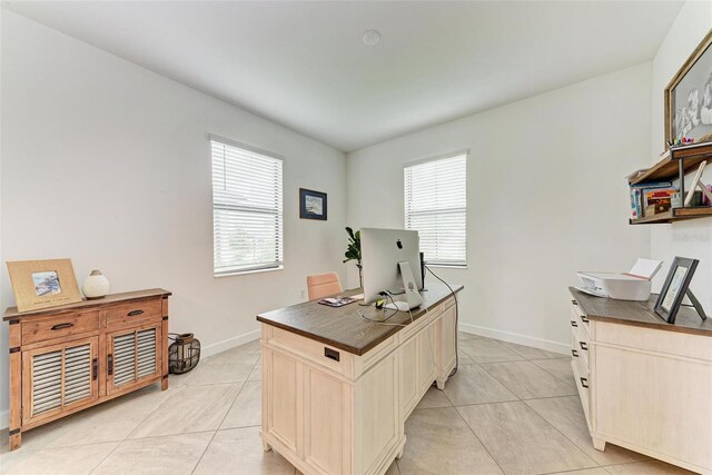 office featuring light tile patterned floors and a healthy amount of sunlight