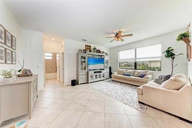 tiled living room with ceiling fan