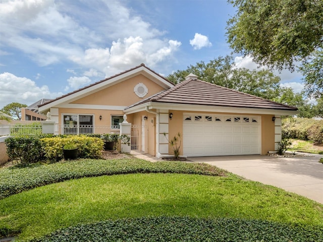 single story home with a garage and a front lawn