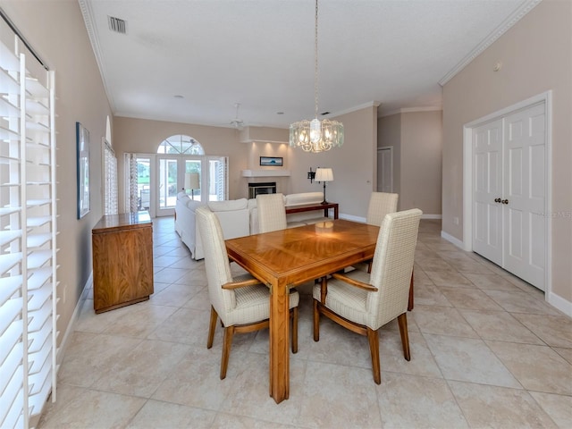 dining area with crown molding, light tile patterned floors, and an inviting chandelier