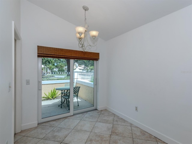 unfurnished dining area with light tile patterned floors, lofted ceiling, and a notable chandelier