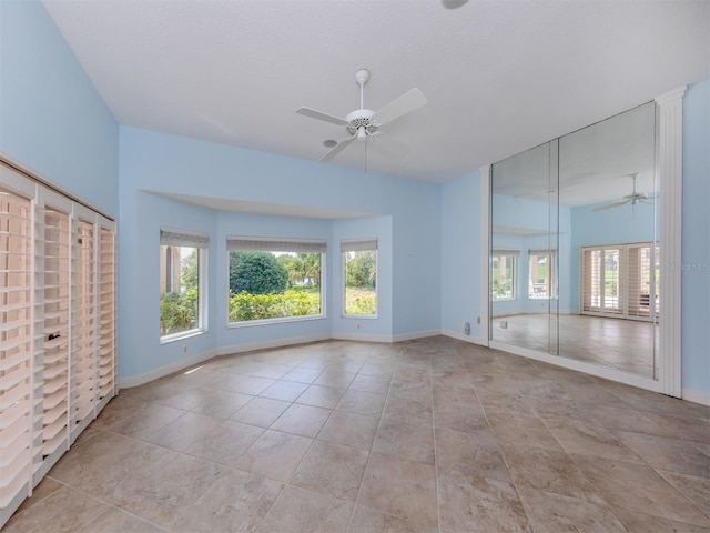 spare room featuring a textured ceiling and ceiling fan