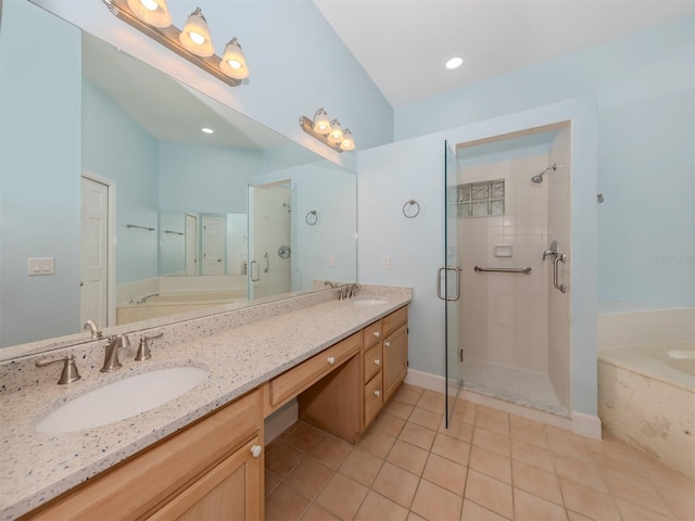 bathroom featuring vanity, tile patterned flooring, and plus walk in shower