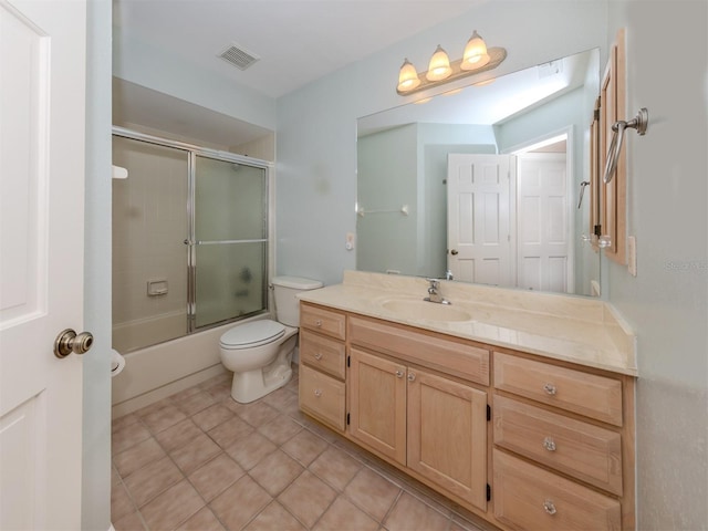 full bathroom with tile patterned floors, vanity, toilet, and shower / bath combination with glass door