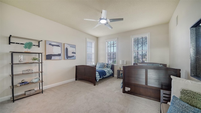 carpeted bedroom featuring a textured ceiling and ceiling fan