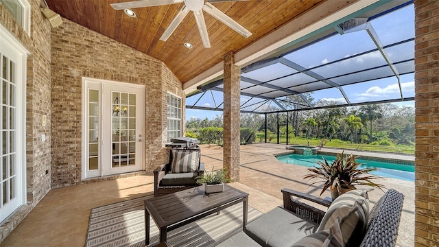 view of patio with ceiling fan, a lanai, and a swimming pool with hot tub